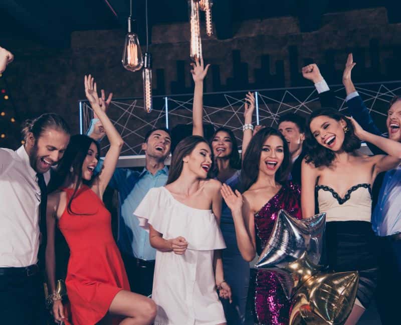 graduates celebrating at a dance club