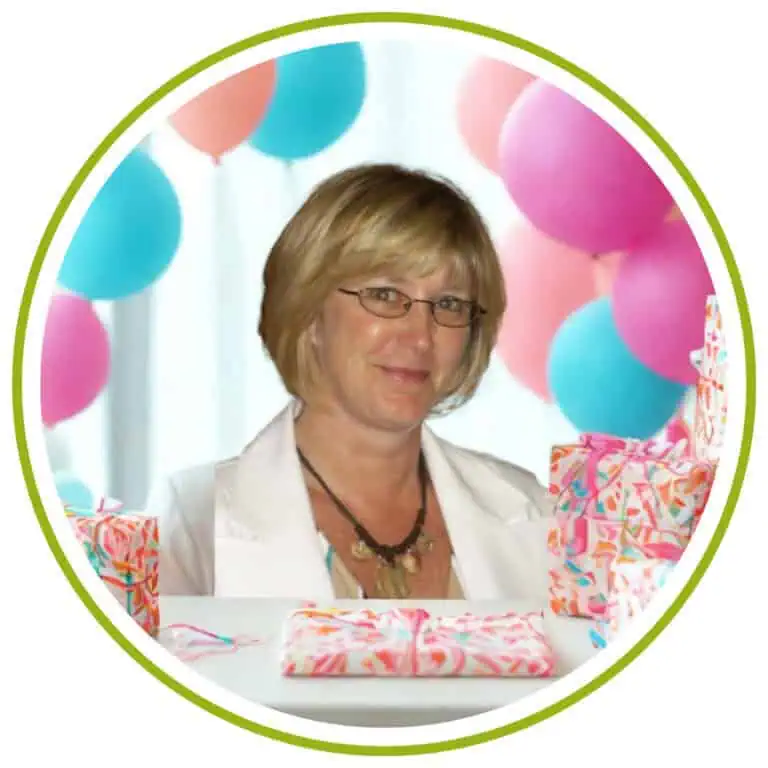 Bright woman with glasses at online gift store surrounded by colorful balloons and wrapped presents.