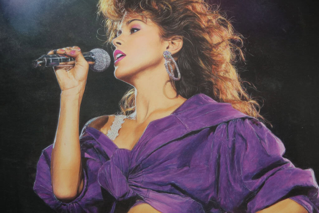 Beautiful woman performing on stage holding a microphone, showcasing jewelry and fashion accessories at the best online gift store.